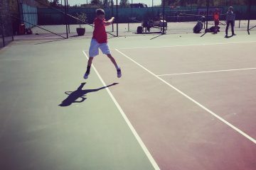 Alex in full shadow swing forehands in the tram lines